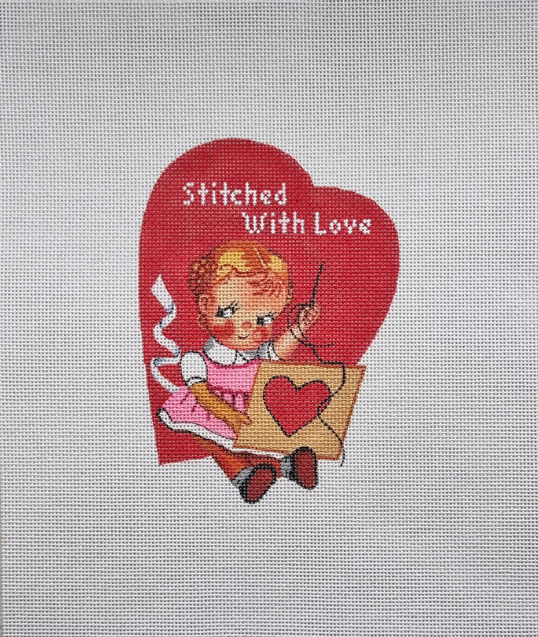 Needlepoint design of a girl holding a heart with 'Stitched With Love' text on a red heart background.